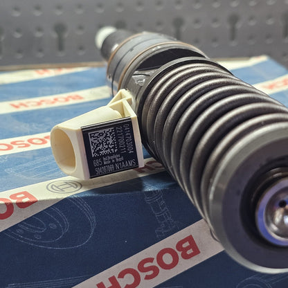 BOSCH fuel injector with product label attached, displayed on a blue background with the BOSCH logo.